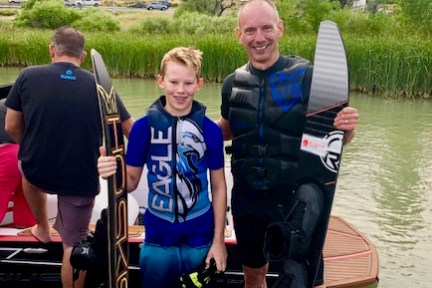 man and boy posing with skis
